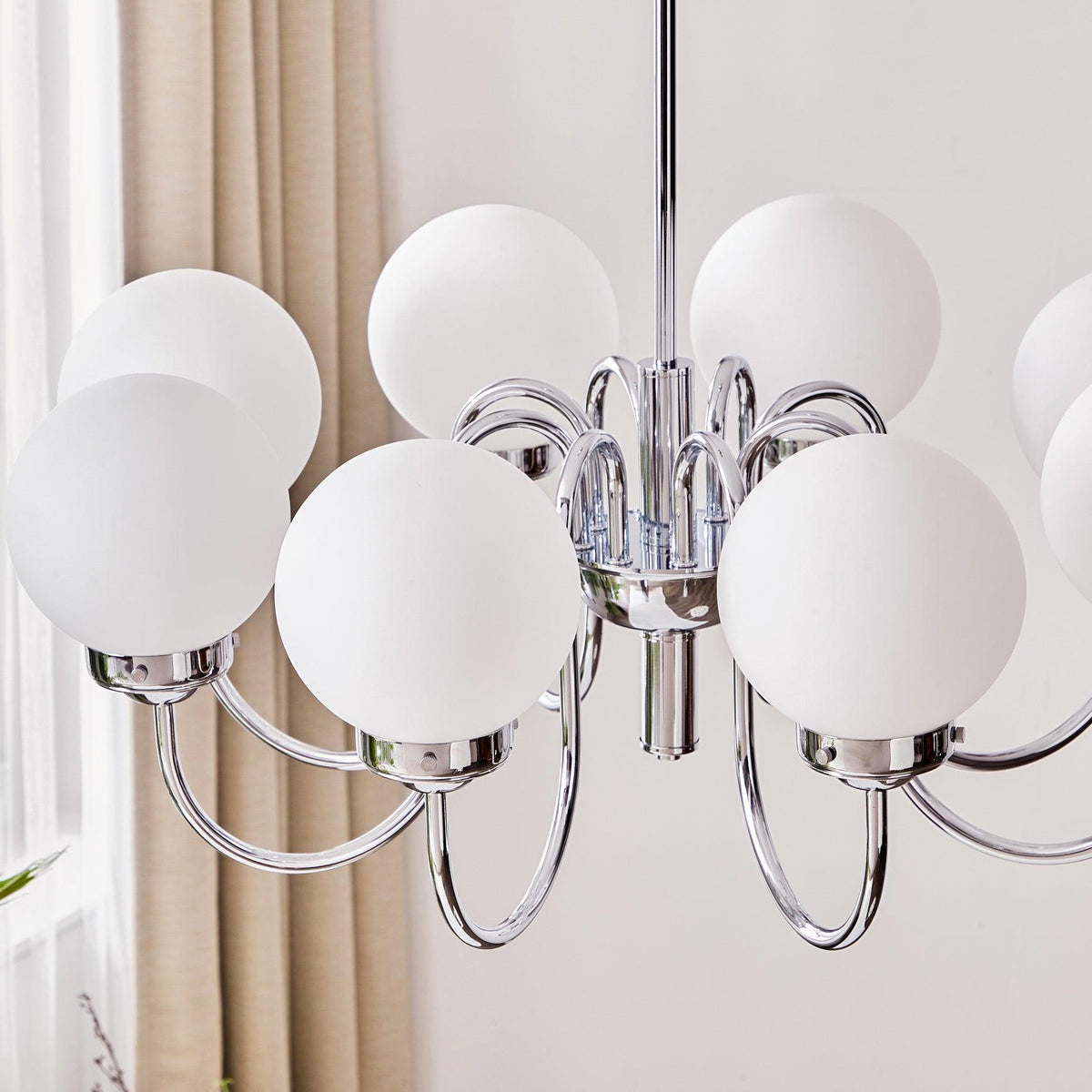 Candelabro Dostor com globos, acabamento cromado e braços curvos