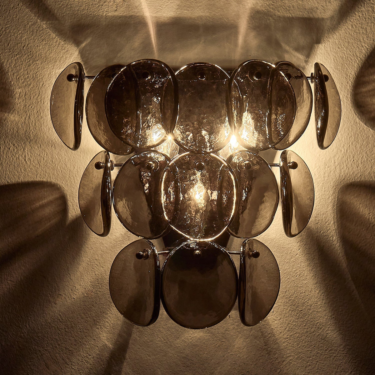 Velearia vägglampa med bärnstensfärgad glasskiva i fiskfjällsmönster och mässing