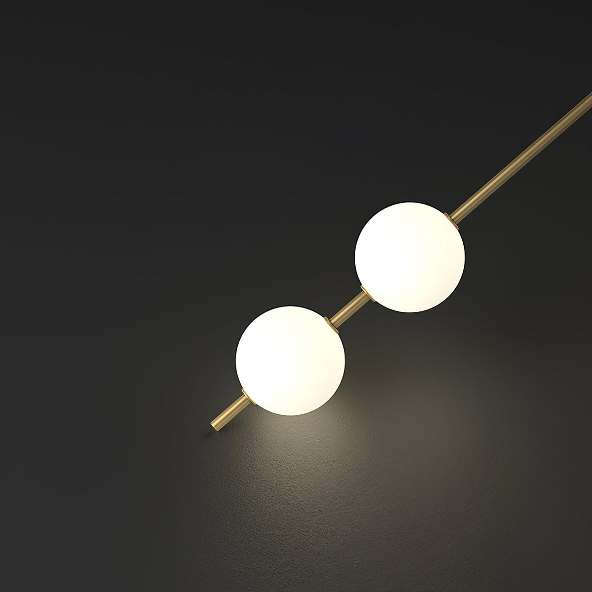 Luminária de parede Soloiella com bolas verticais em latão
